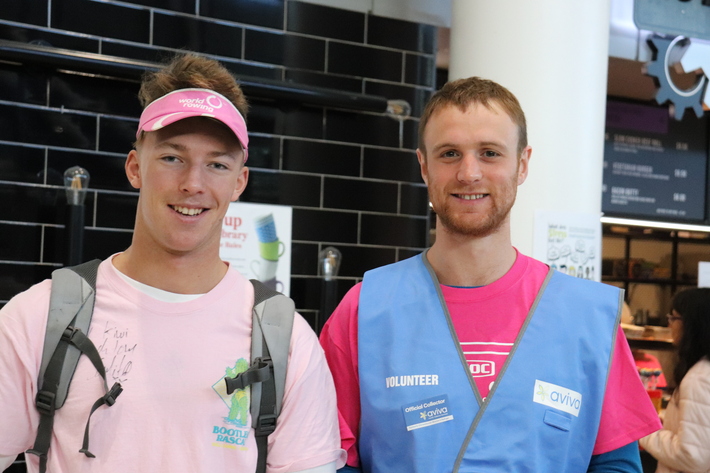 Two young men in a blue Aviva vest collecting for Aviva Street Appeal